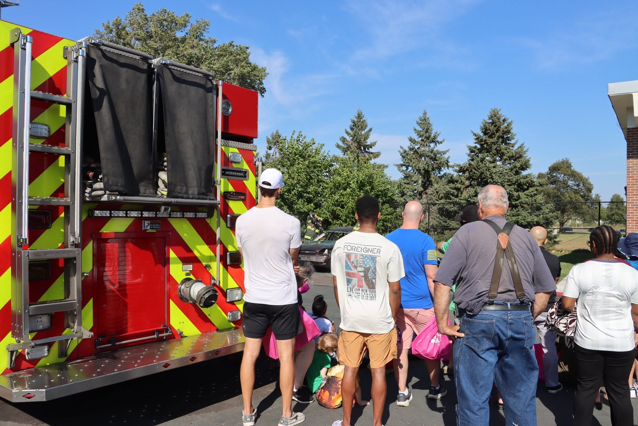 Community members gathered around a fire truck at a public safety event