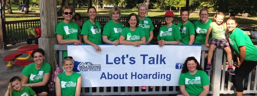 MNHTF team holding Let's Talk About Hoarding banner at park event
