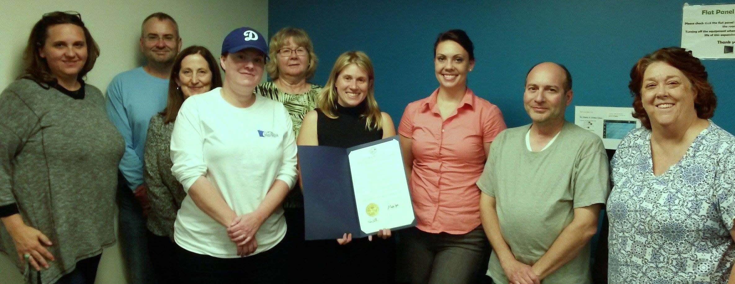 MNHTF team receiving a proclamation indoors