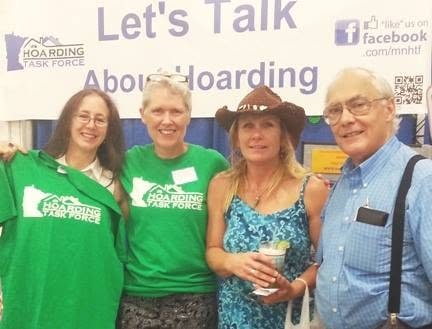 Four MNHTF volunteers at Let's Talk About Hoarding booth