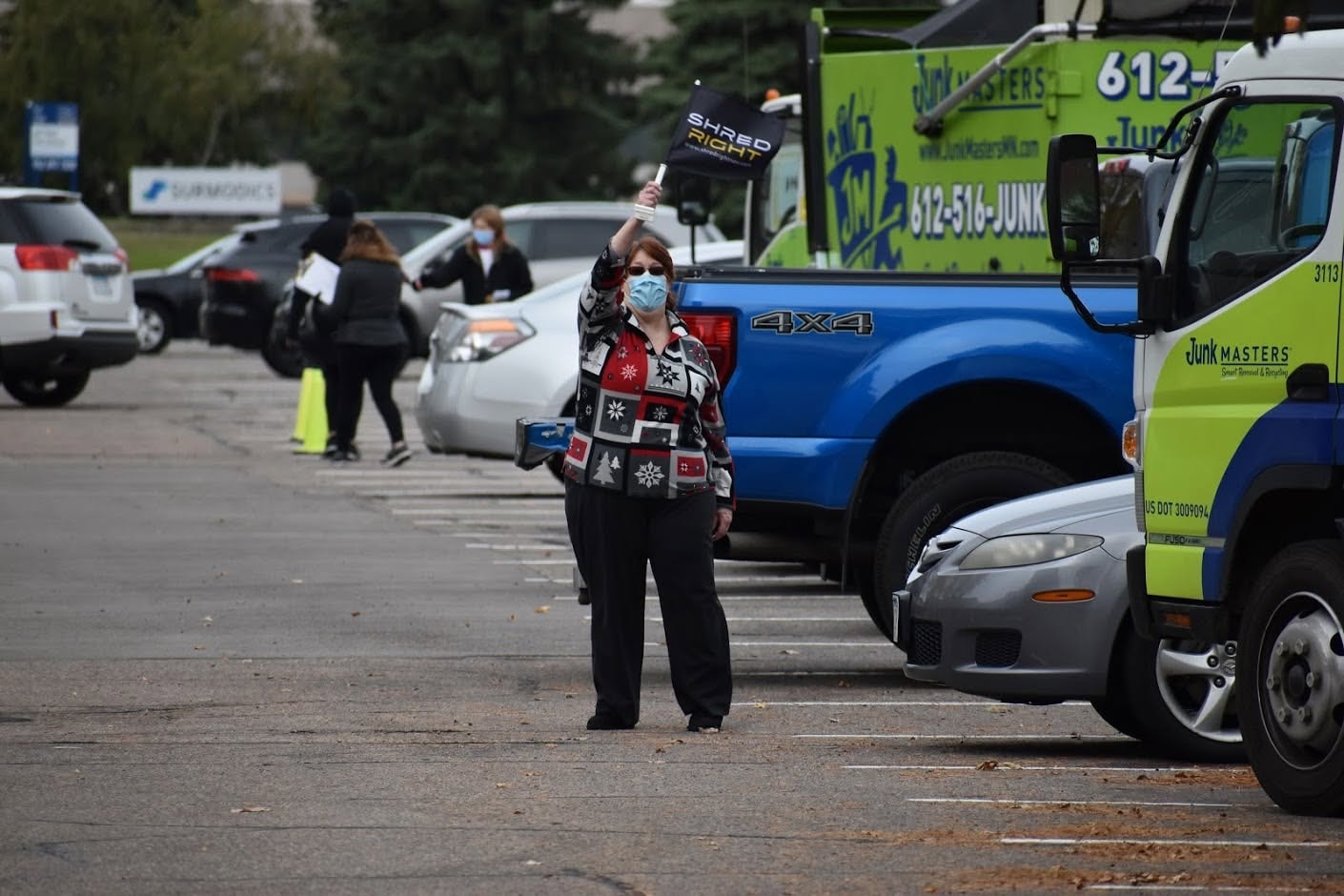 Volunteer directing traffic at Shred Right parking lot event